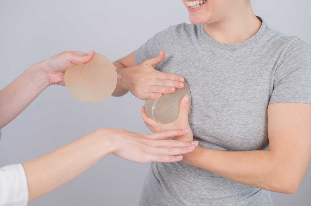patient checking out implants for breast augmentation